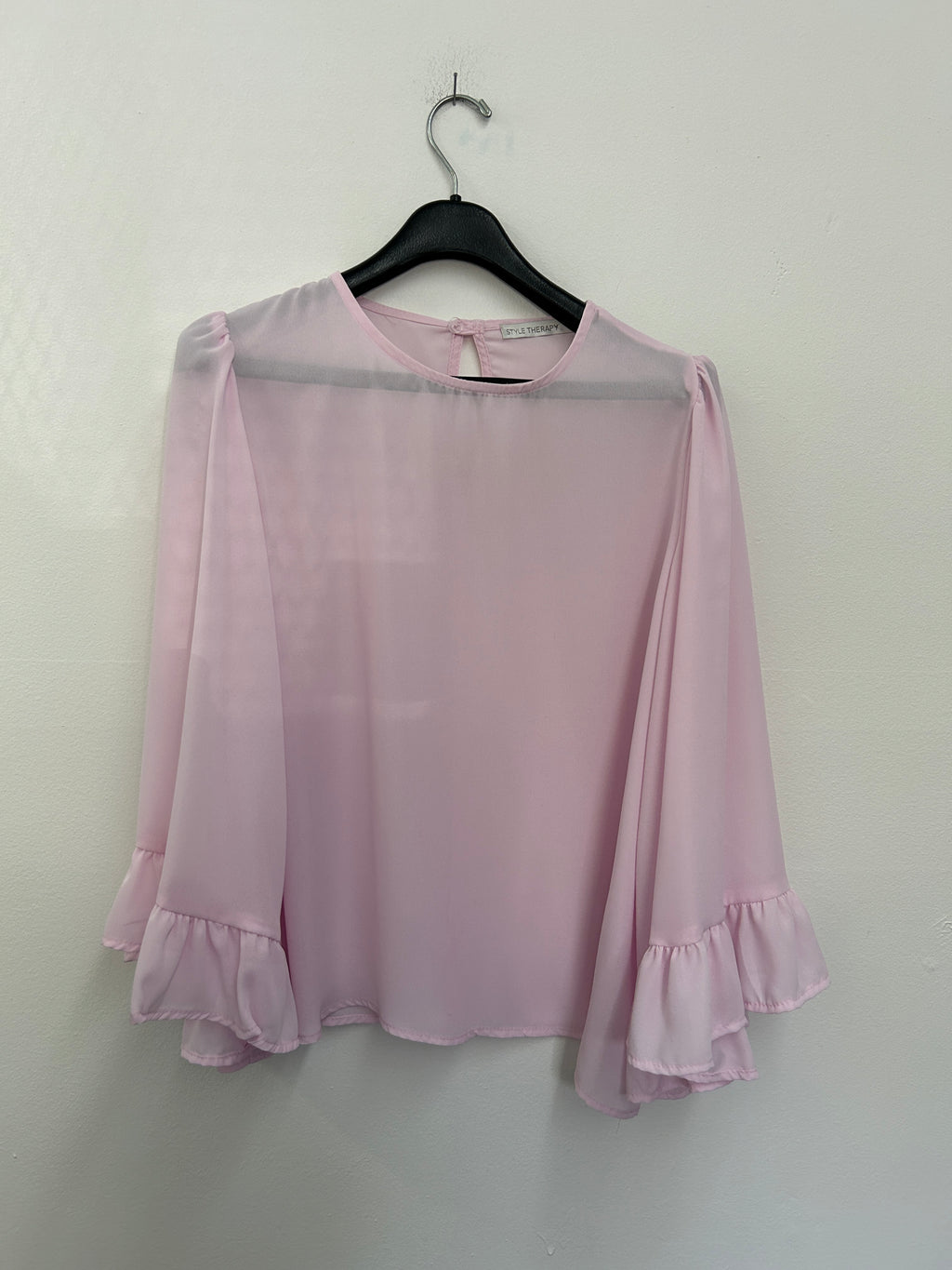 Blouse rose pâle à manches évasées